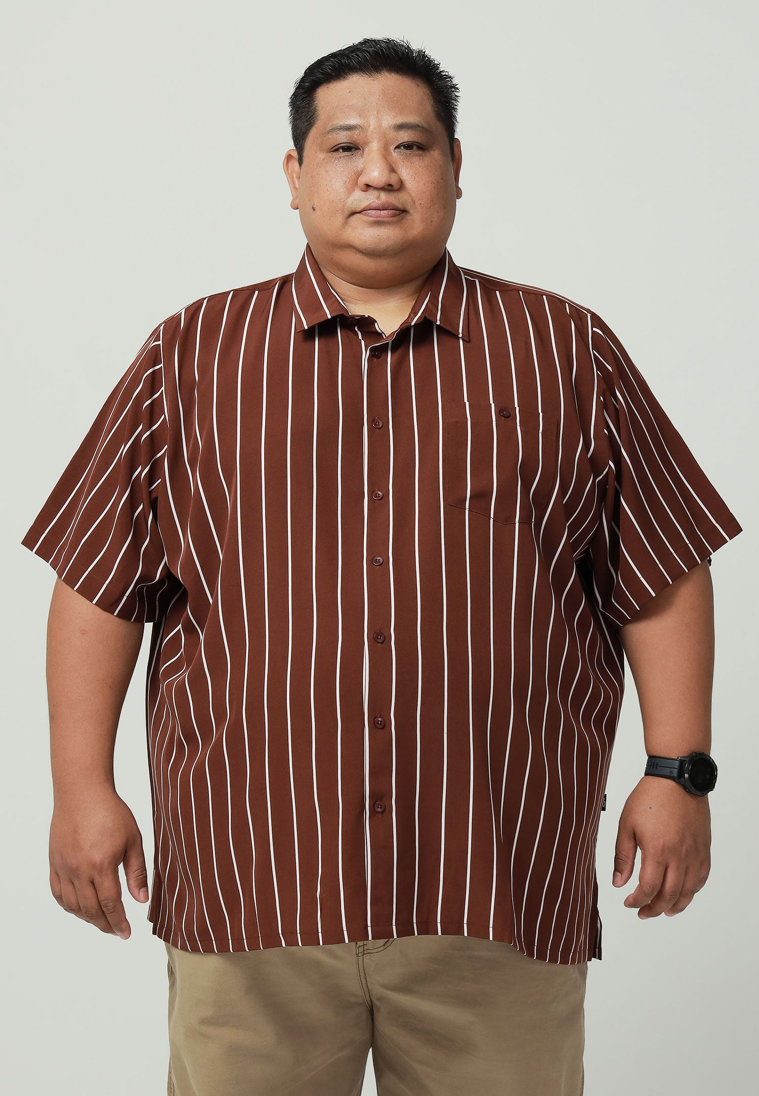 A plus-size male model wearing a brown shirt with white stripes #color_brown