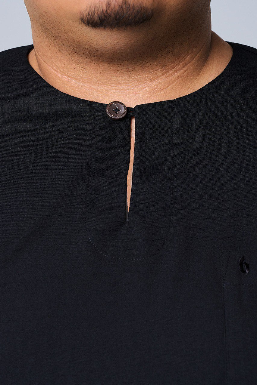 Close-up of a black shirt with a button on a plain background #color_black