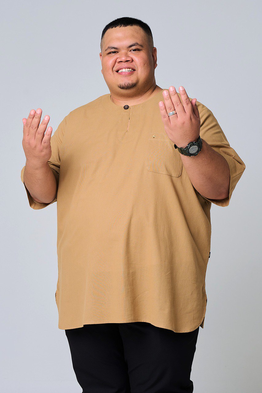 Man wearing a brown shirt and black pants on a plain background #color_brown