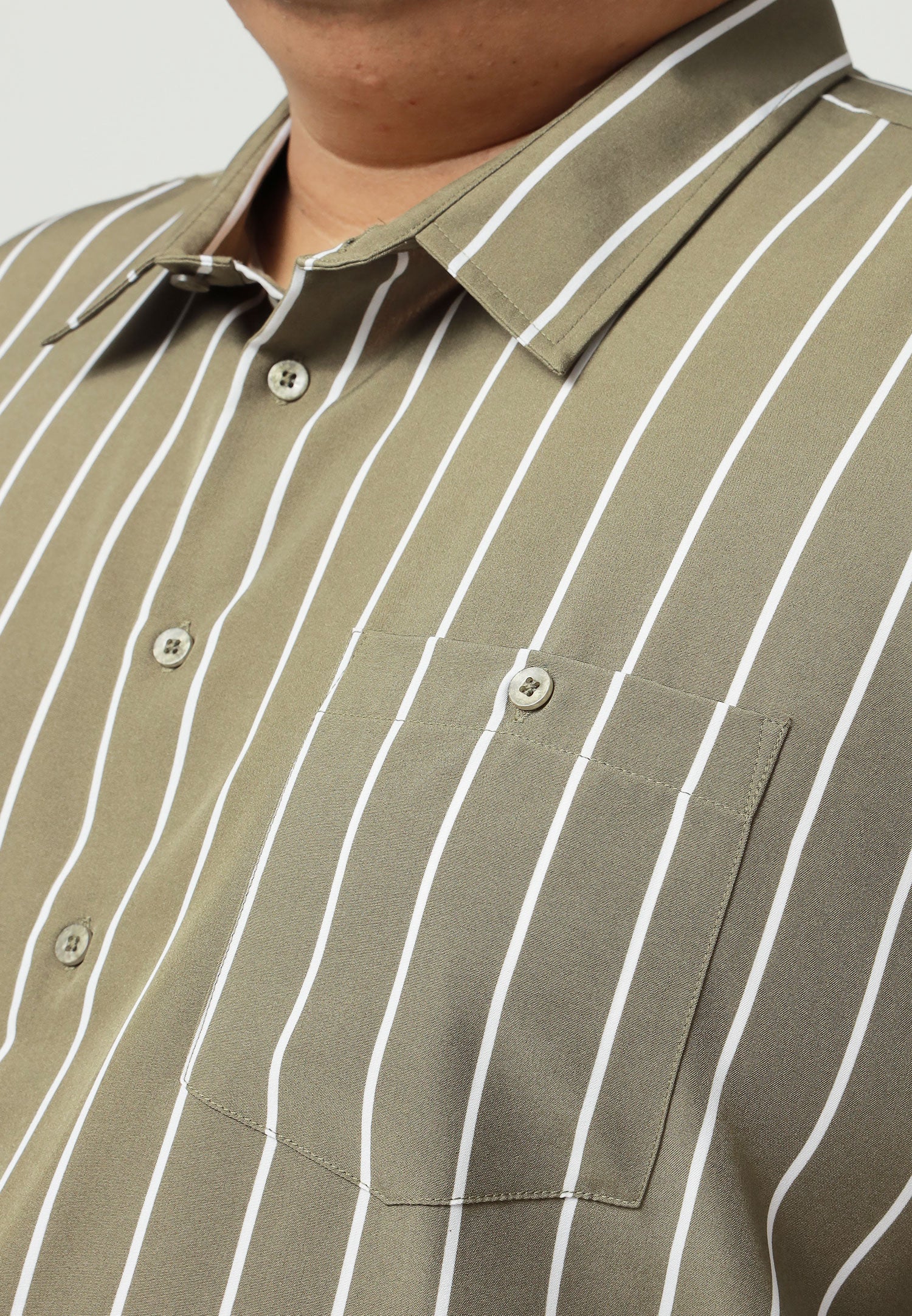 A close up of pointed collar and left chest pocket with button for olive green shirt with white stripes #color_olive green