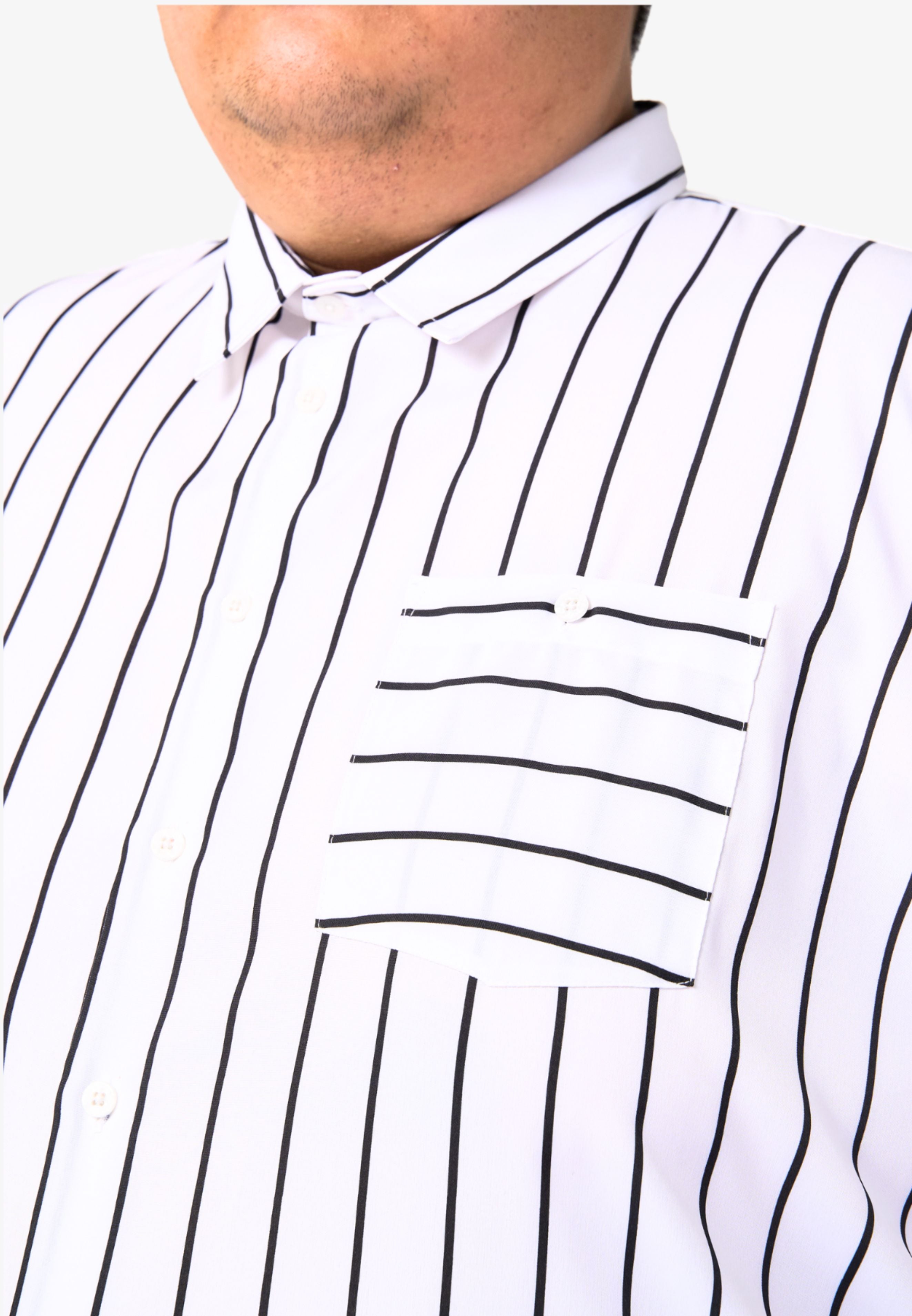 A close up of pointed collar and left chest pocket with button for white shirt with black stripes #color_white